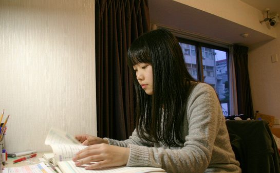 高中生在台灯下订正试卷